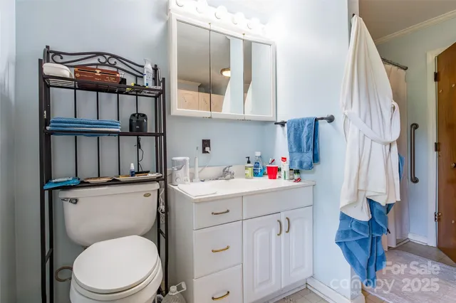 a bathroom with a toilet a sink and a mirror