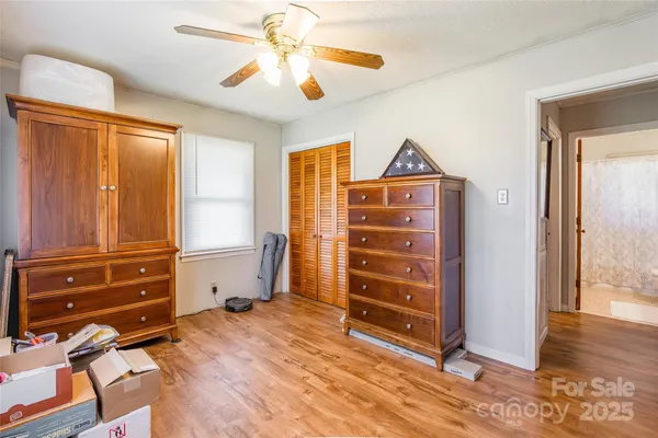 a view of a bedroom with closet and cabinet