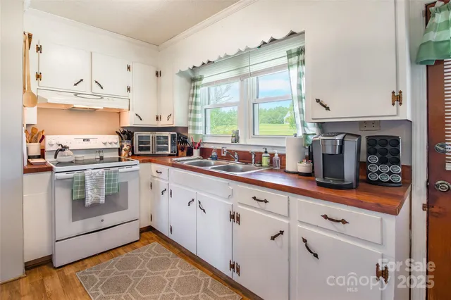 a kitchen with stainless steel appliances granite countertop a sink and cabinets