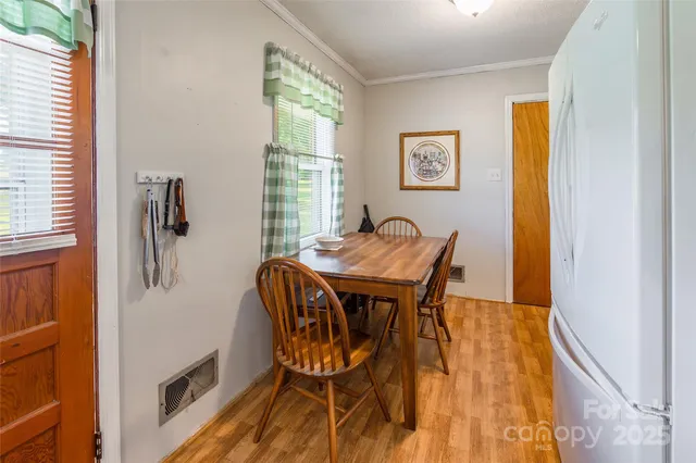 a view of a dining room with furniture and a window