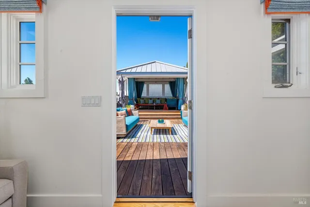 a view of a patio with couches table and chairs and potted plants