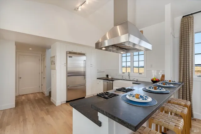 a kitchen with stainless steel appliances granite countertop a stove sink and refrigerator