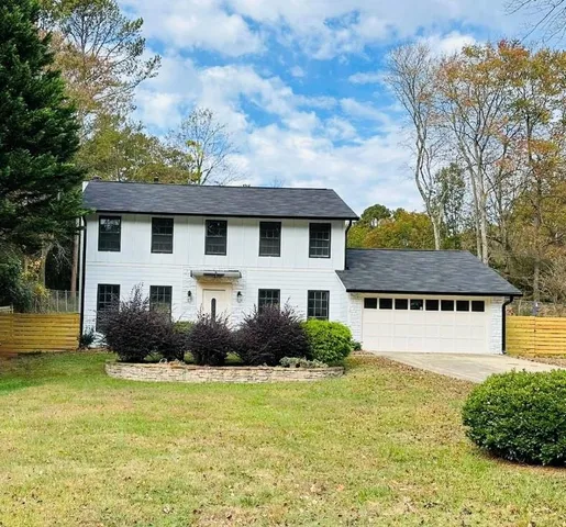 a front view of a house with garden