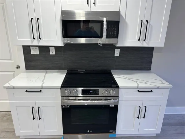 a stove top oven sitting inside of a kitchen