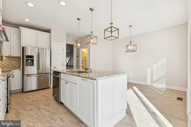 a kitchen with a stove a refrigerator a sink and dishwasher