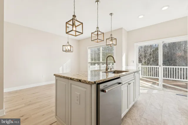 a kitchen with a sink and a wooden floor