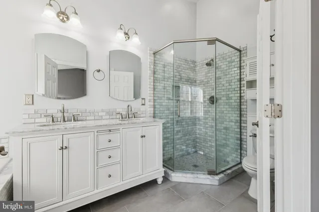 a bathroom with a double vanity sink mirror and double