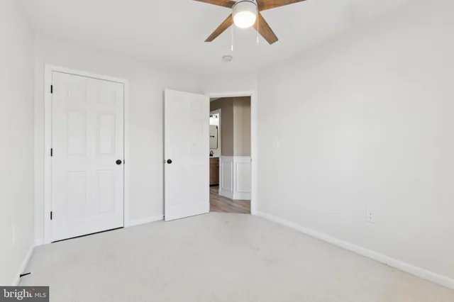 a view of hallway with chandelier fan