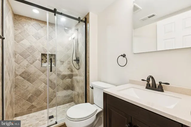 a bathroom with a sink toilet and shower