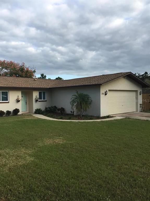 3115 Winchester Drive Dunedin, FL 34698 - Photo 1 of 1 a view of outdoor kitchen and garden