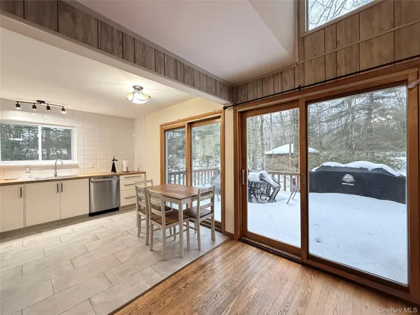 a view of a kitchen with dining area and chandelier