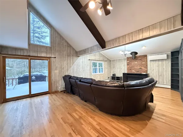 a living room with couches and wooden floor