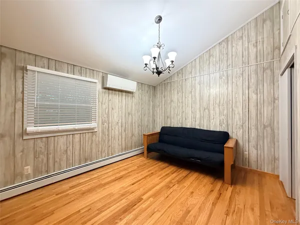 a living room with a bed and a rug