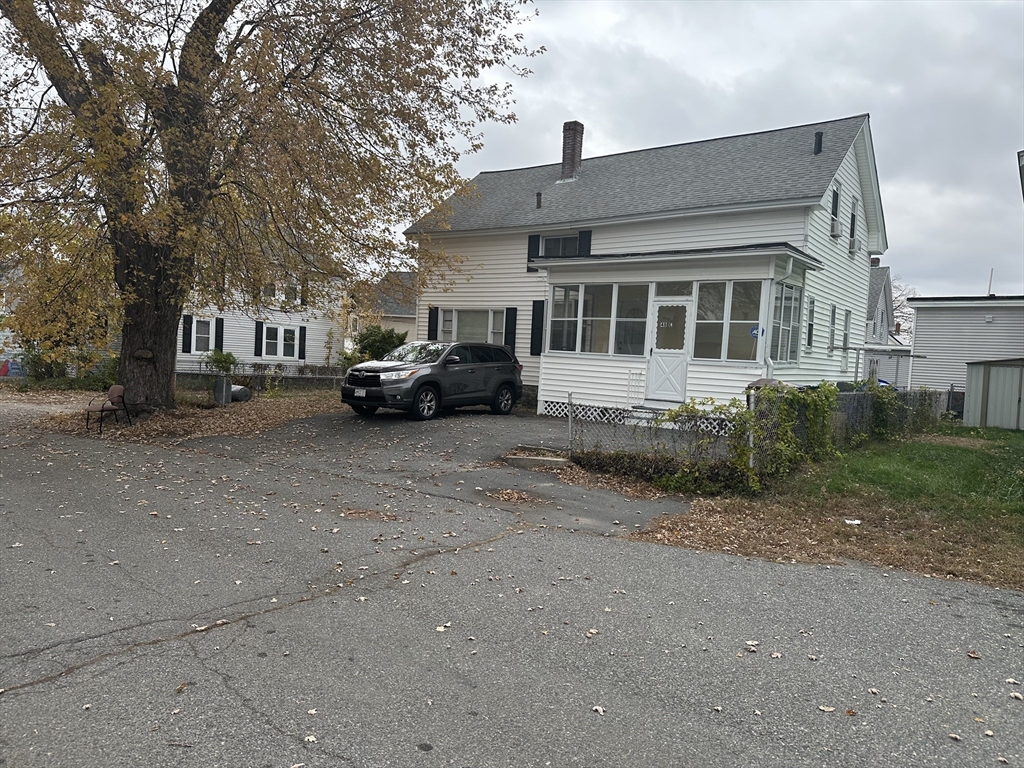 48 E Street Lowell, MA 01851 - Photo 1 of 14 a car parked in front of a house