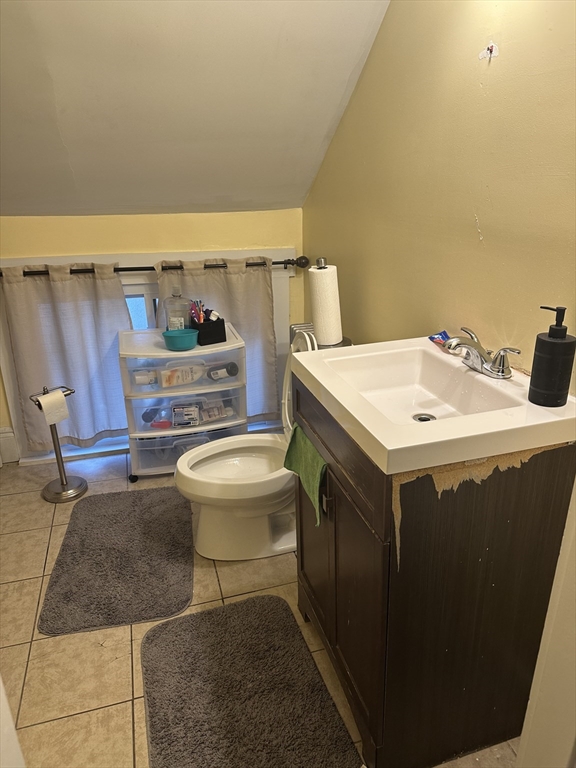 48 E Street Lowell, MA 01851 - Photo 11 of 14 a bathroom with a sink a toilet and a mirror