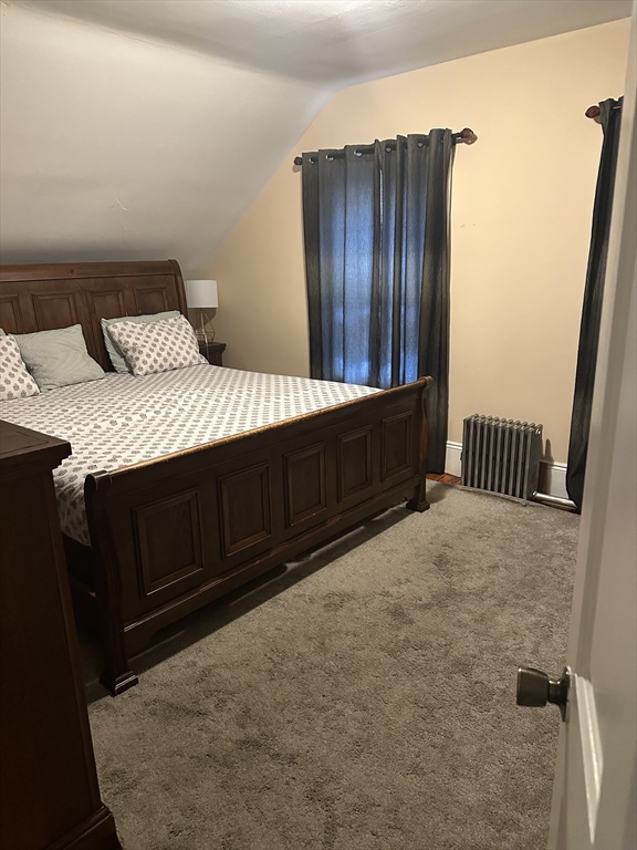 48 E Street Lowell, MA 01851 - Photo 2 of 14 a bedroom with a bed and wooden floor