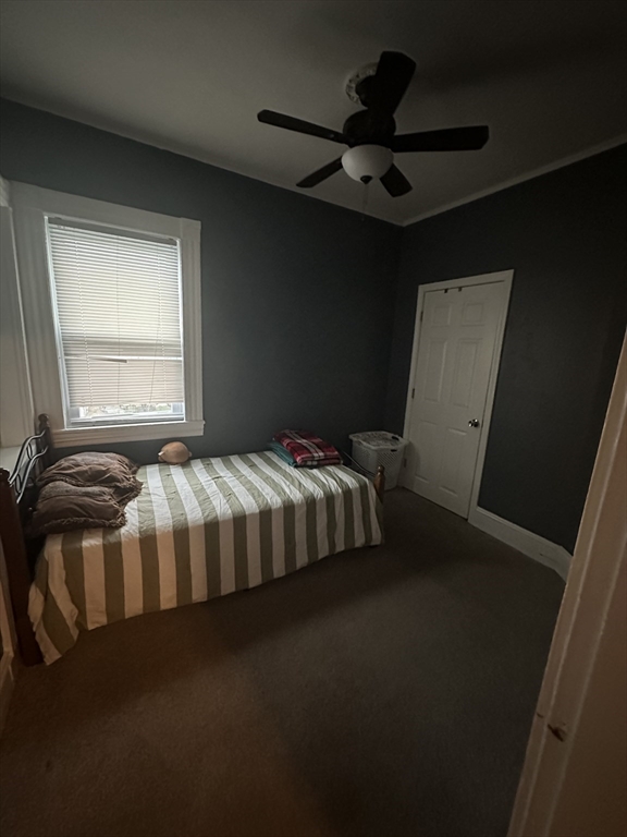 48 E Street Lowell, MA 01851 - Photo 4 of 14 a bed sitting in a bedroom next to a window