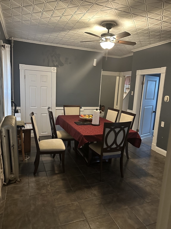 48 E Street Lowell, MA 01851 - Photo 8 of 14 a dining room with furniture and a chandelier