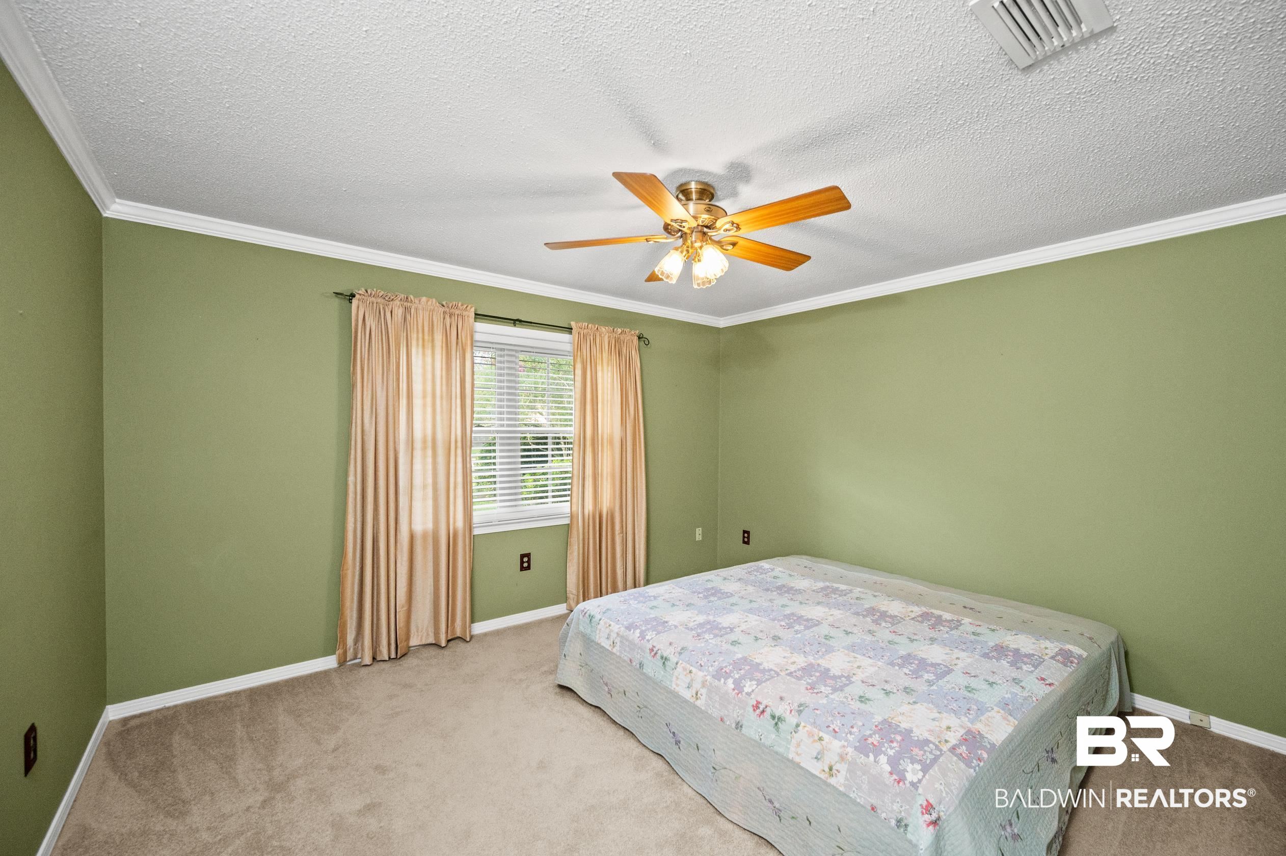 303 West Palm Avenue Foley, AL 36535 - Photo 16 of 32 Bedroom featuring ornamental molding, light carpet, a textured ceiling, and ceiling fan
