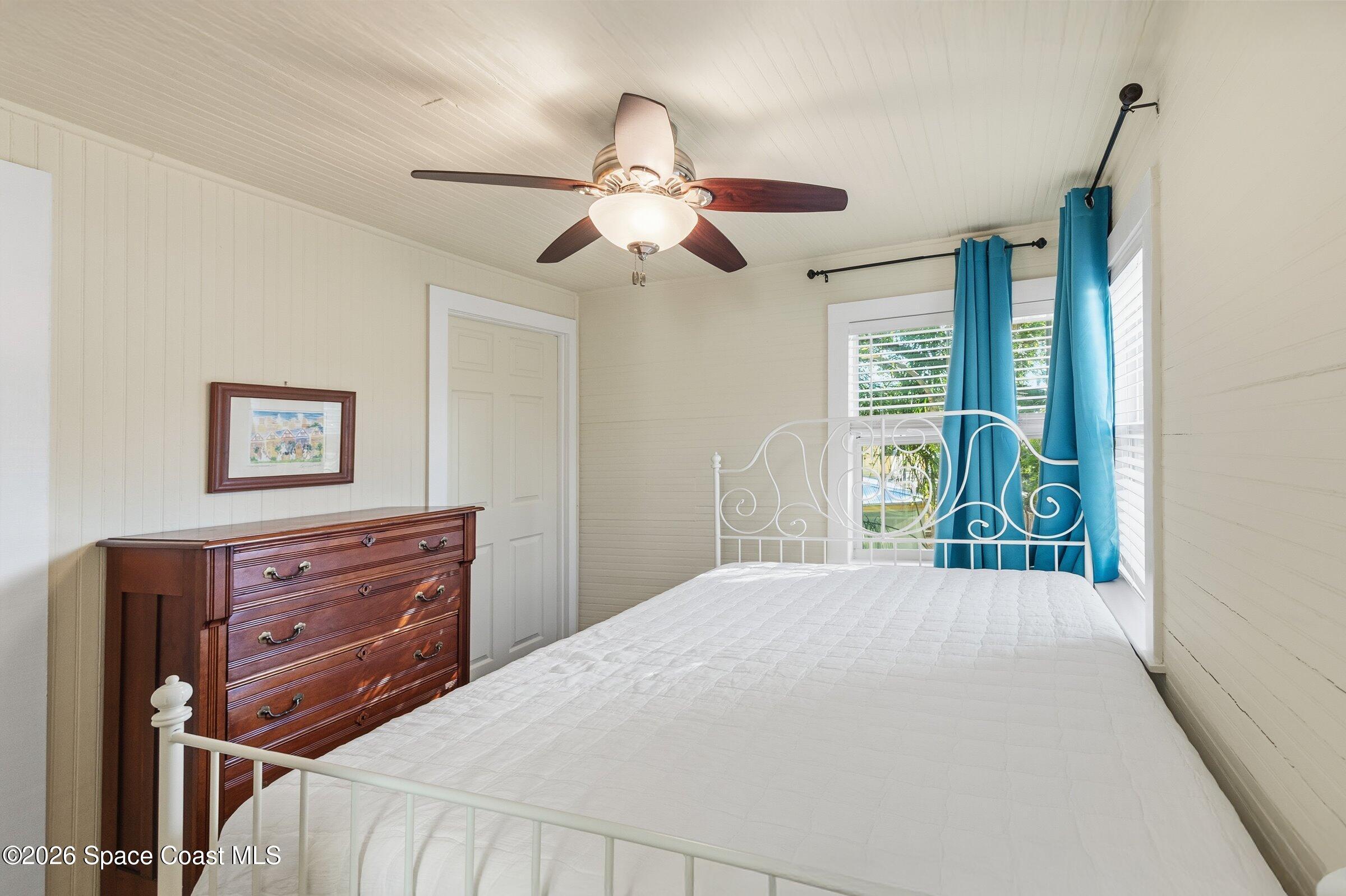 11 Mitchell Street Cocoa, FL 32922 - Photo 140 of 159 a bedroom with a bed and a chandelier