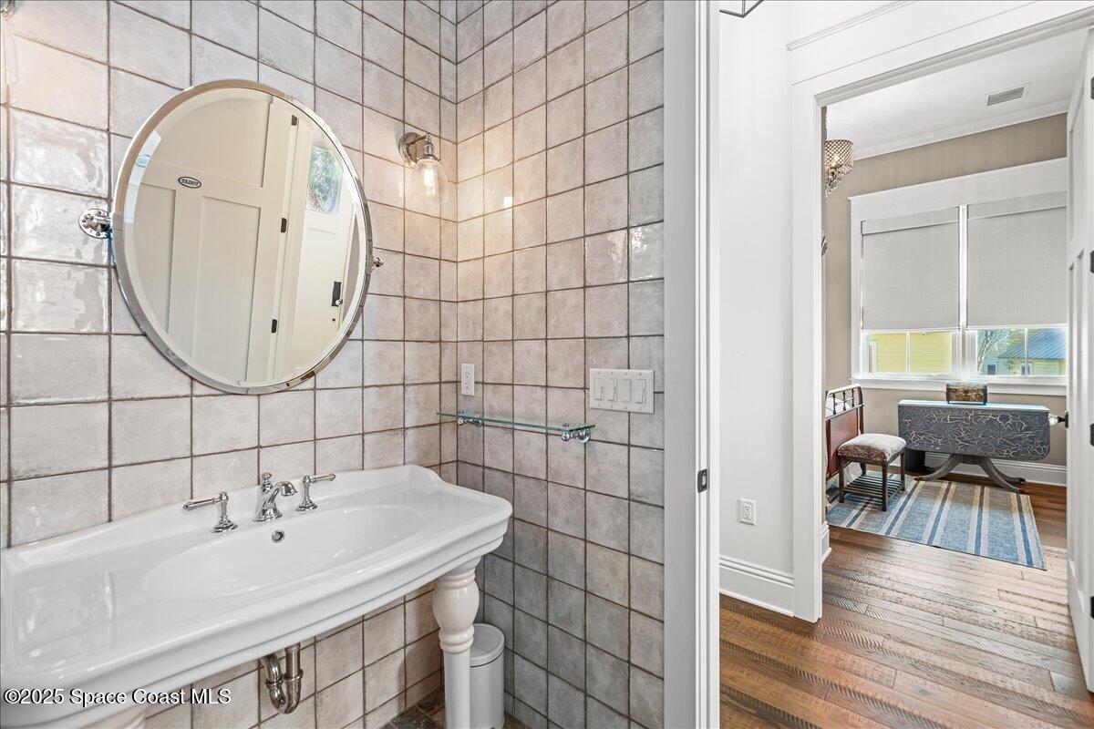 11 Mitchell Street Cocoa, FL 32922 - Photo 29 of 159 a bathroom with a sink a mirror and a shower
