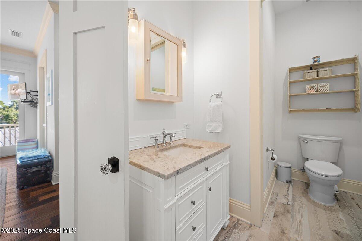 11 Mitchell Street Cocoa, FL 32922 - Photo 45 of 159 a bathroom with a granite countertop sink toilet and a mirror