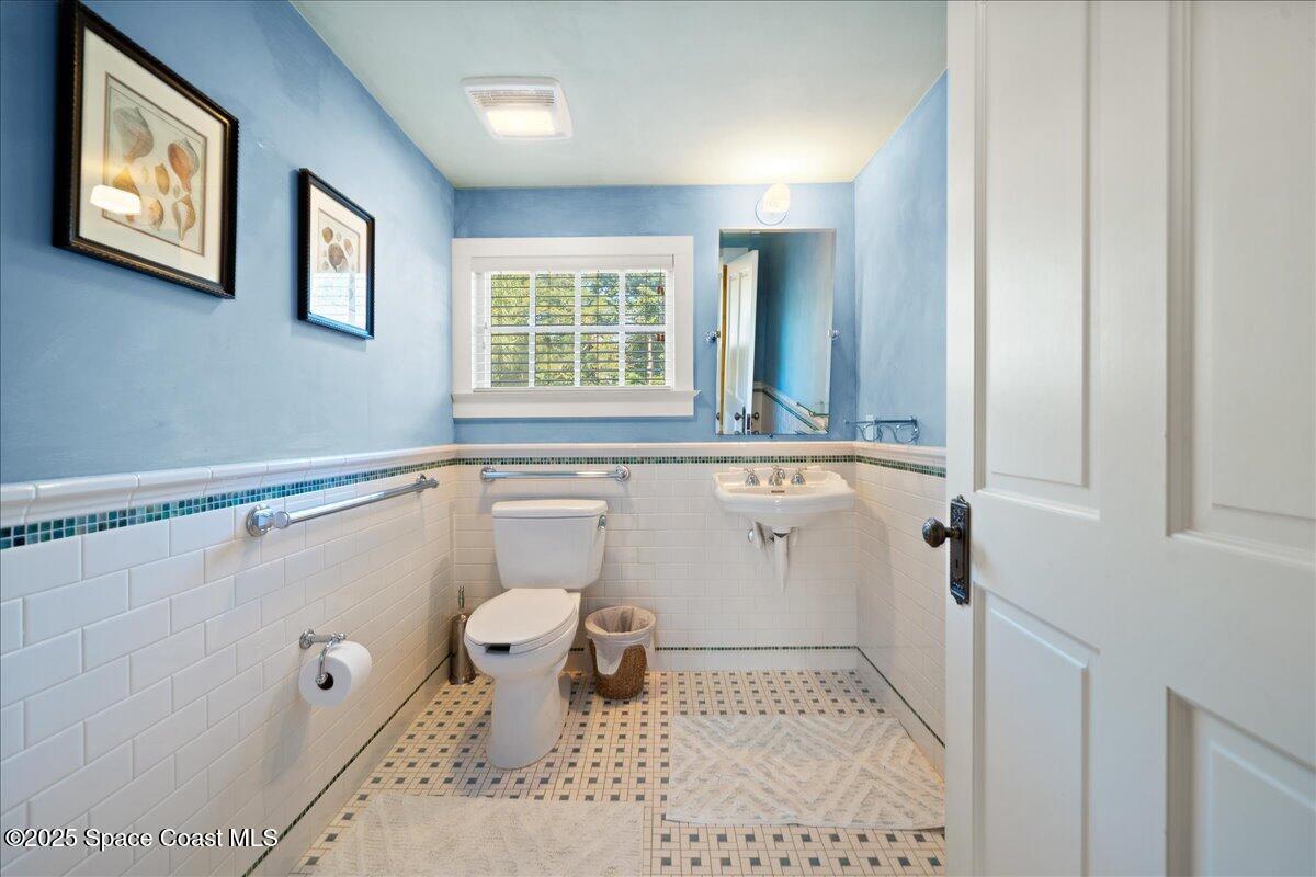 11 Mitchell Street Cocoa, FL 32922 - Photo 77 of 159 a bathroom with a sink a toilet and a window