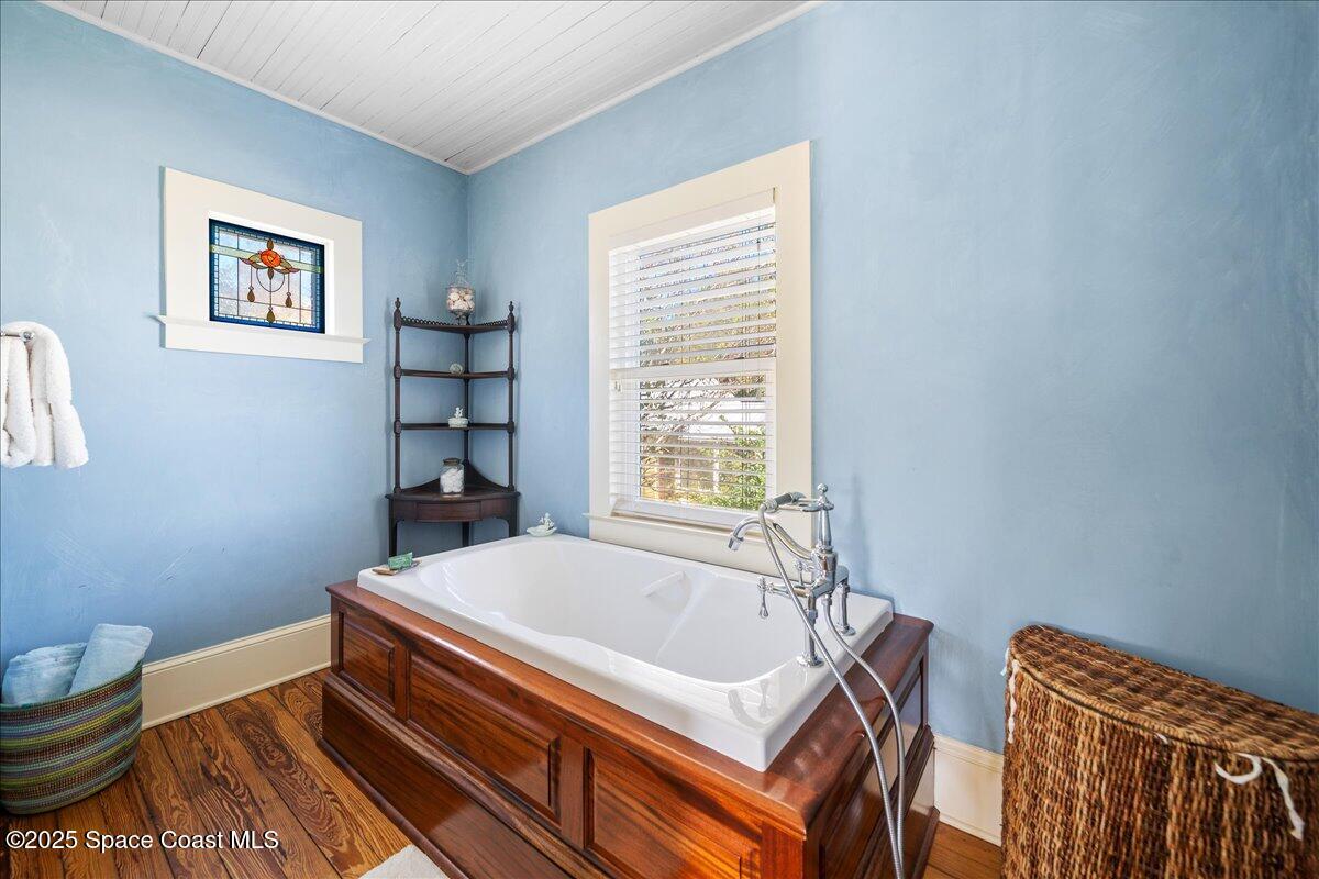 11 Mitchell Street Cocoa, FL 32922 - Photo 83 of 159 a bath tub sitting next to a blue bench