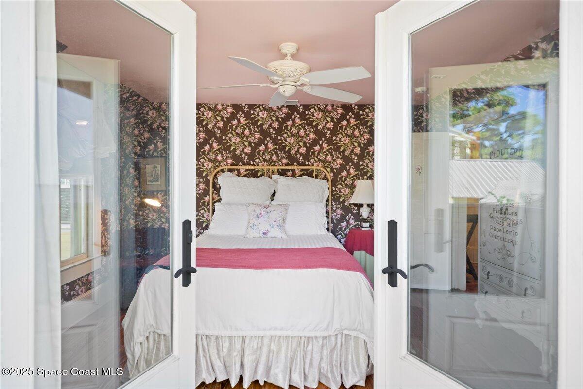 11 Mitchell Street Cocoa, FL 32922 - Photo 90 of 159 a bedroom with a bed and a chandelier