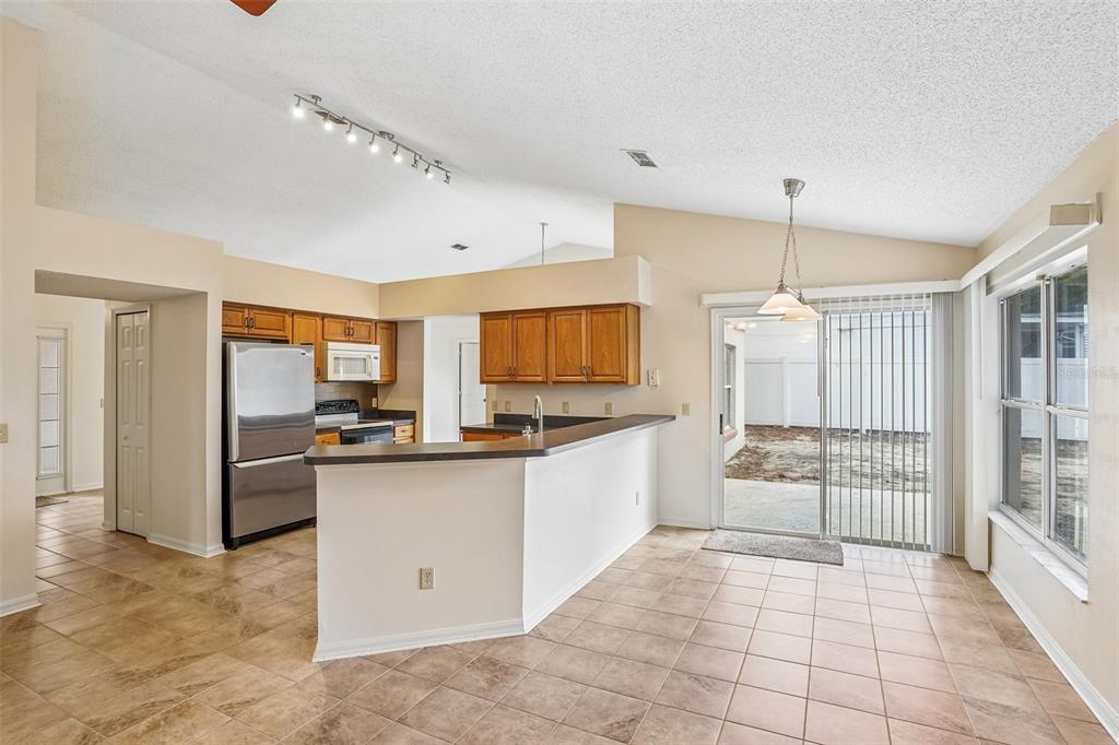 2596 Alclobe Circle Ocoee, FL 34761 - Photo 18 of 70 a large white kitchen with a large window and stainless steel appliances