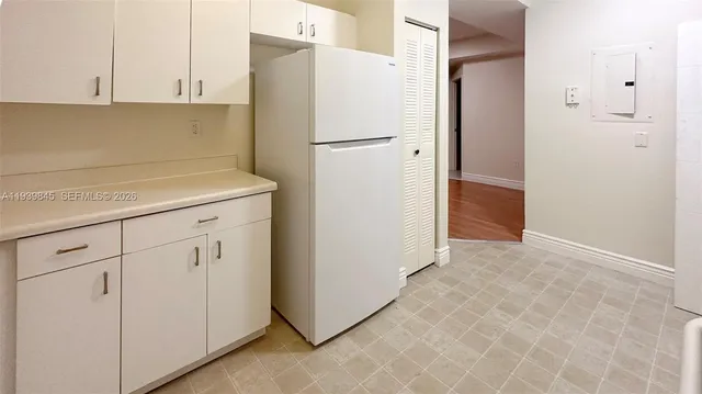 a white refrigerator freezer sitting in a kitchen
