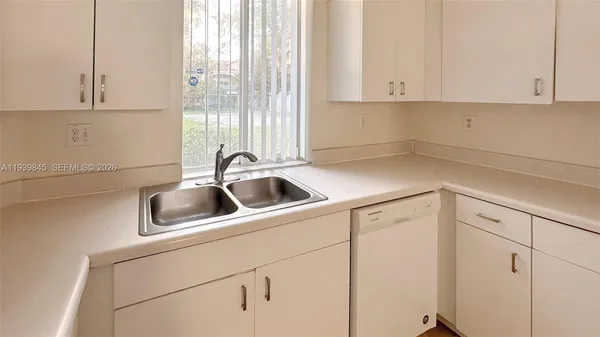 a kitchen with a sink and cabinets