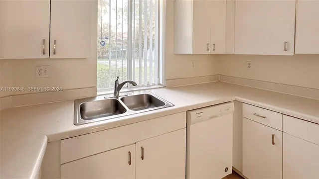 a kitchen with a sink and cabinets