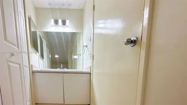 a bathroom with a glass shower door