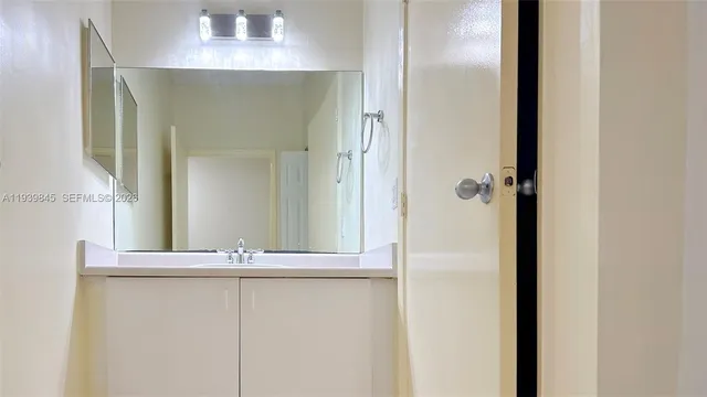 a bathroom with a mirror and a shower