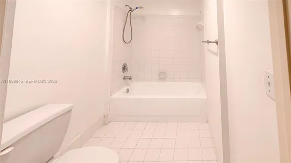 a bathroom with a bathtub and a toilet