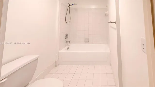 a bathroom with a bathtub and a toilet