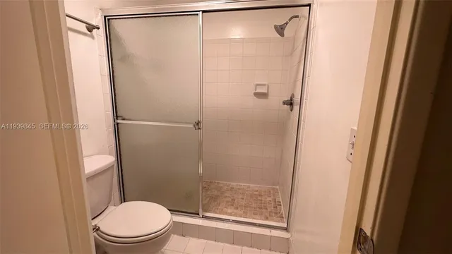 a bathroom with a shower and a toilet