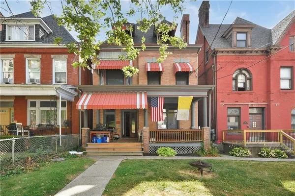 a view of a brick building with a yard