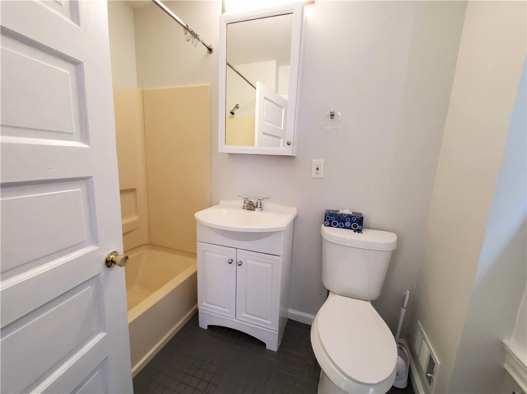 352 North Craig Street, Unit 5 Pittsburgh, PA 15213 - Photo 3 of 10 a white toilet sitting next to a bathroom sink