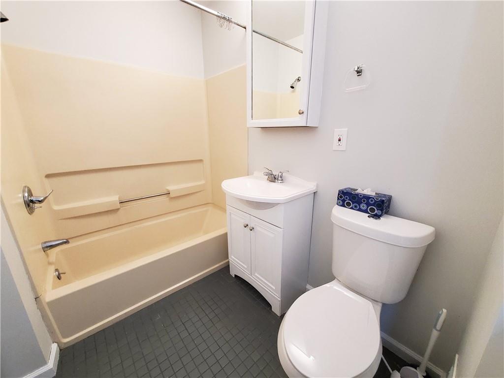 352 North Craig Street, Unit 5 Pittsburgh, PA 15213 - Photo 4 of 10 a bathroom with a toilet sink and mirror