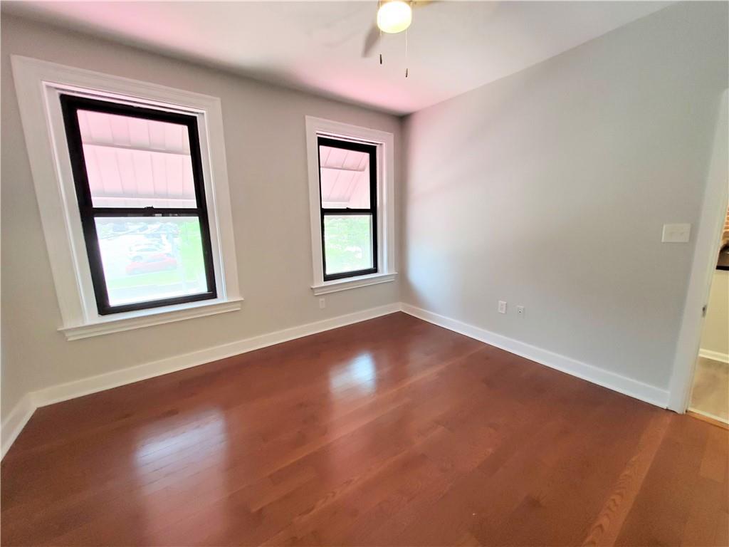352 North Craig Street, Unit 5 Pittsburgh, PA 15213 - Photo 5 of 10 an empty room with wooden floor and windows