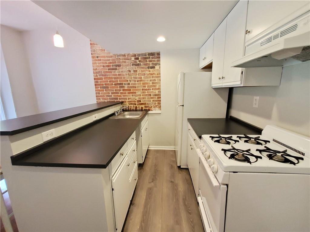352 North Craig Street, Unit 5 Pittsburgh, PA 15213 - Photo 8 of 10 a kitchen with granite countertop a stove and a sink