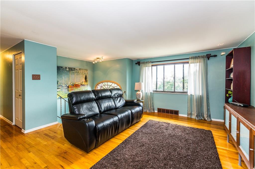 2045 McKees Rocks Road McKees Rocks, PA 15136 - Photo 5 of 25 Living room with hardwood floors and welcoming window through which panoramic views of the city can been seen. You'll LOVE the beautiful skyline sunrises!