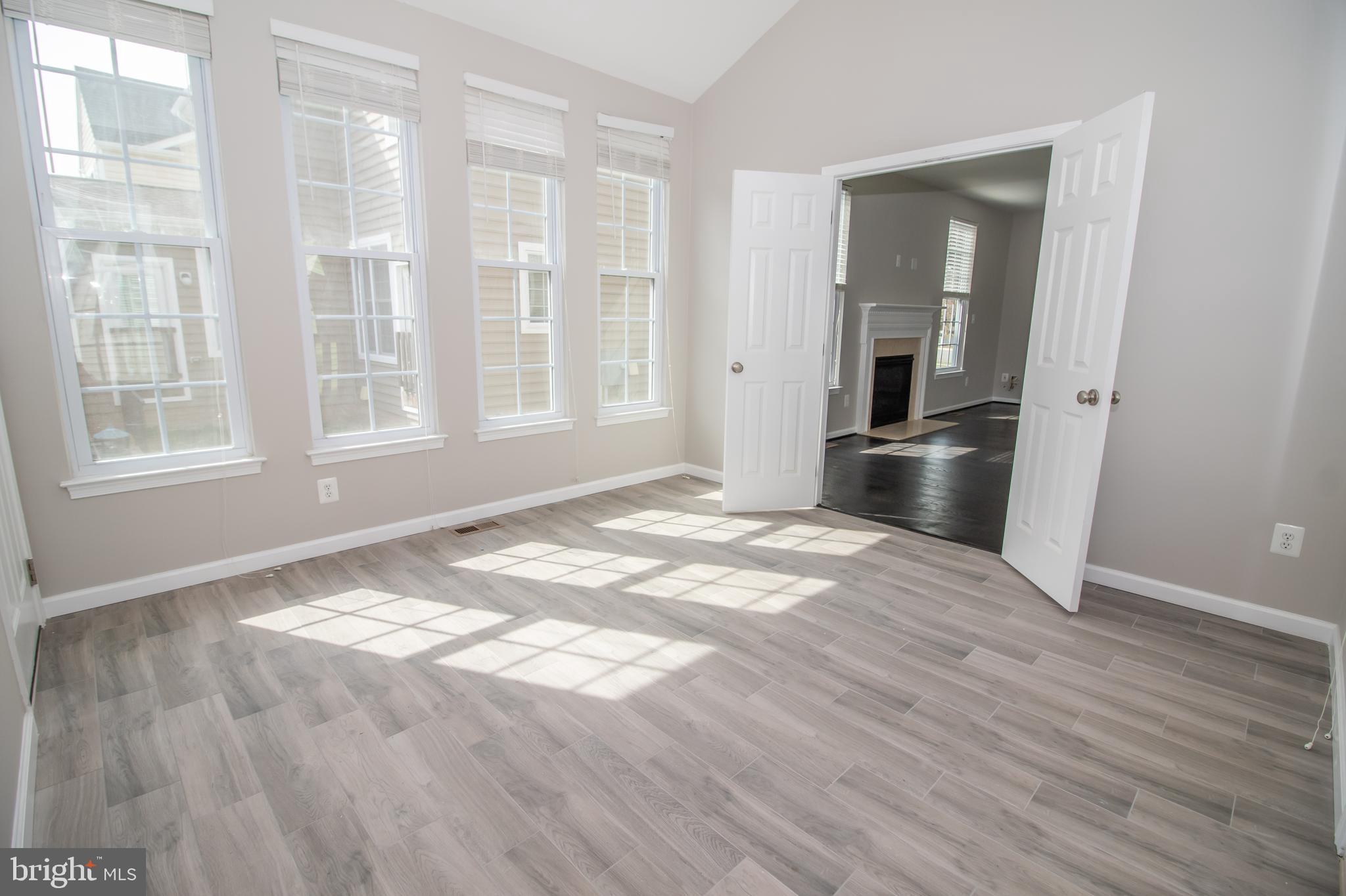 25257 Doolittle Lane Chantilly, VA 20152 - Photo 20 of 52 an empty room with wooden floor and windows