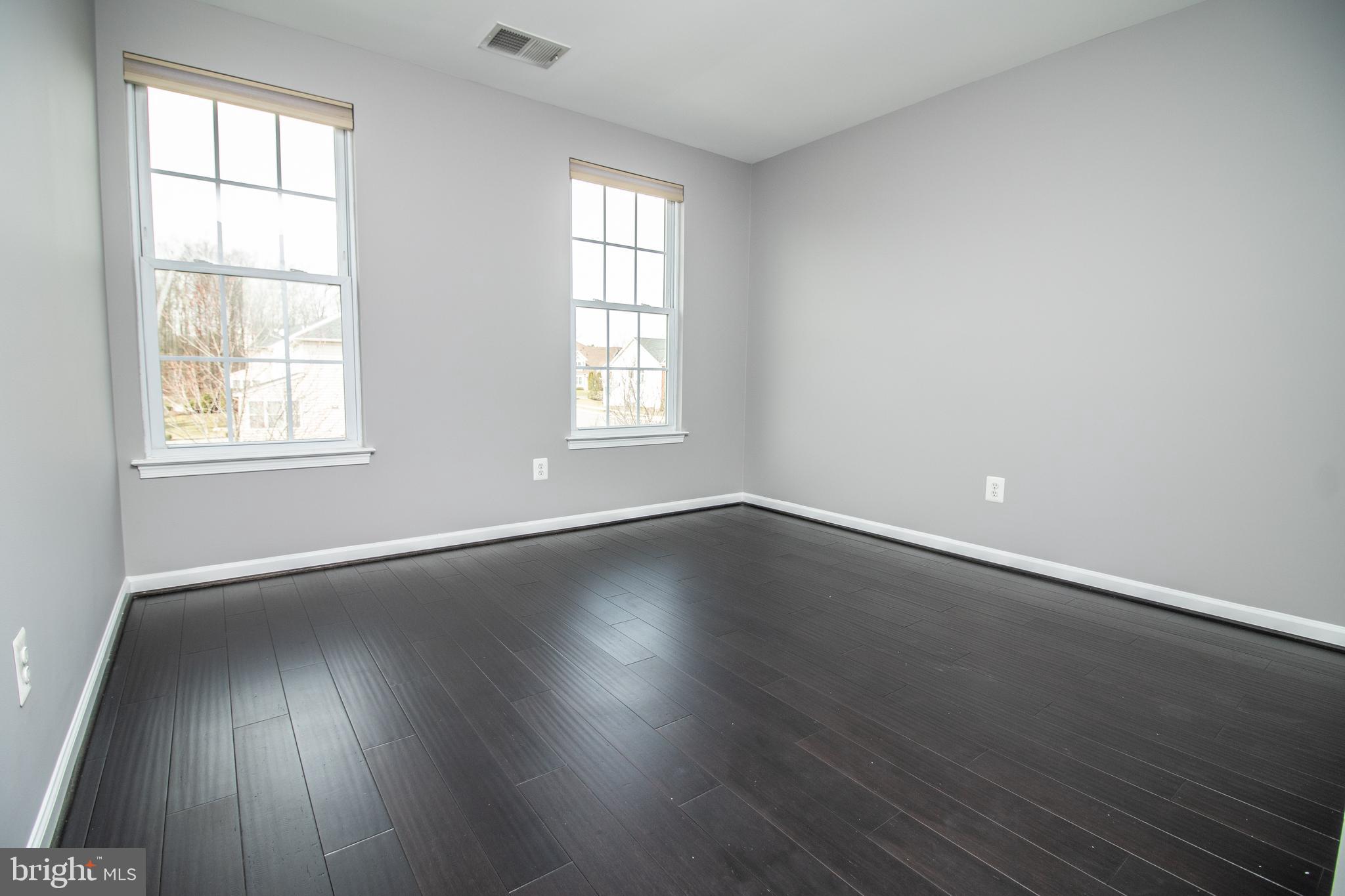 25257 Doolittle Lane Chantilly, VA 20152 - Photo 22 of 52 an empty room with wooden floor and windows