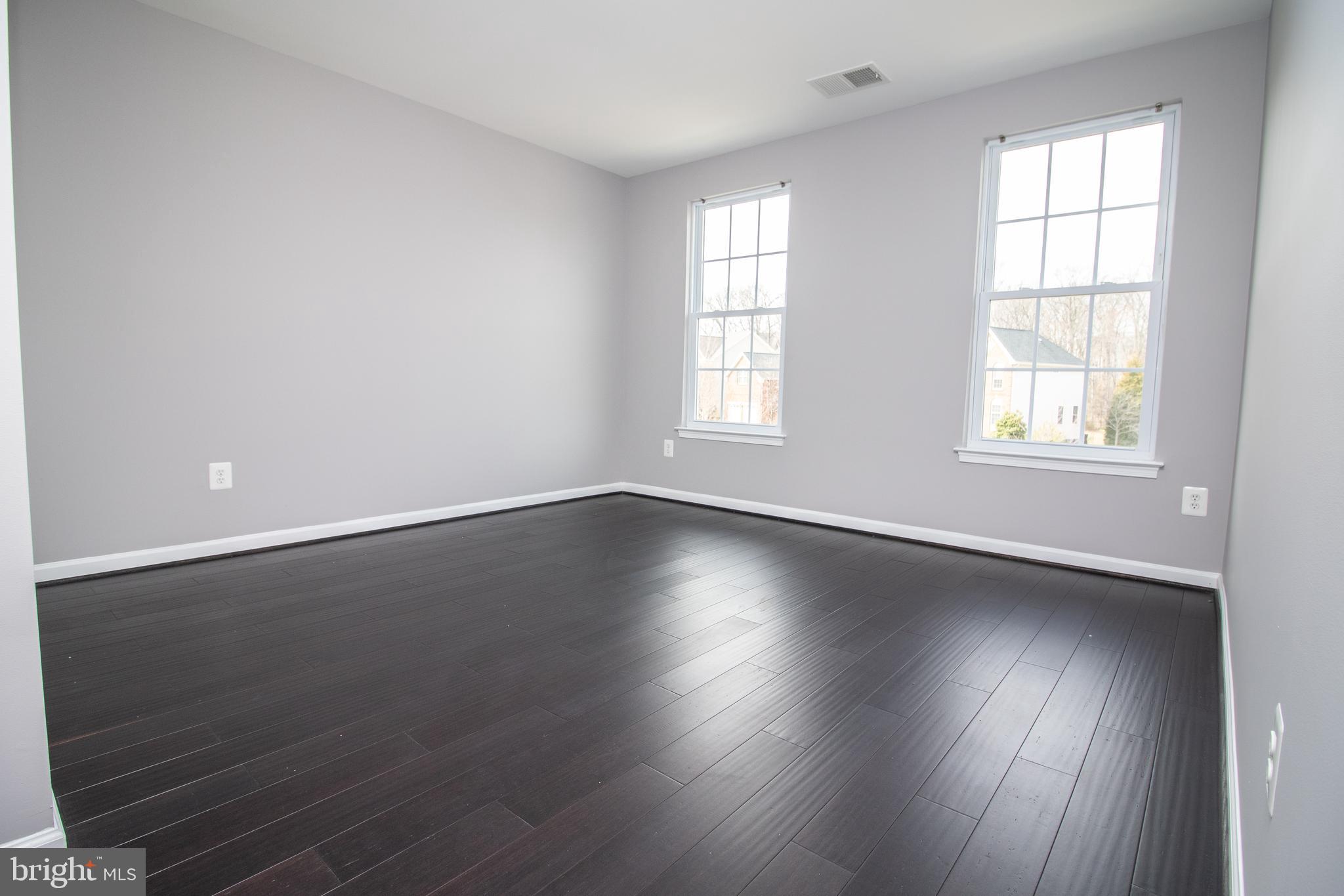 25257 Doolittle Lane Chantilly, VA 20152 - Photo 24 of 52 an empty room with wooden floor and windows