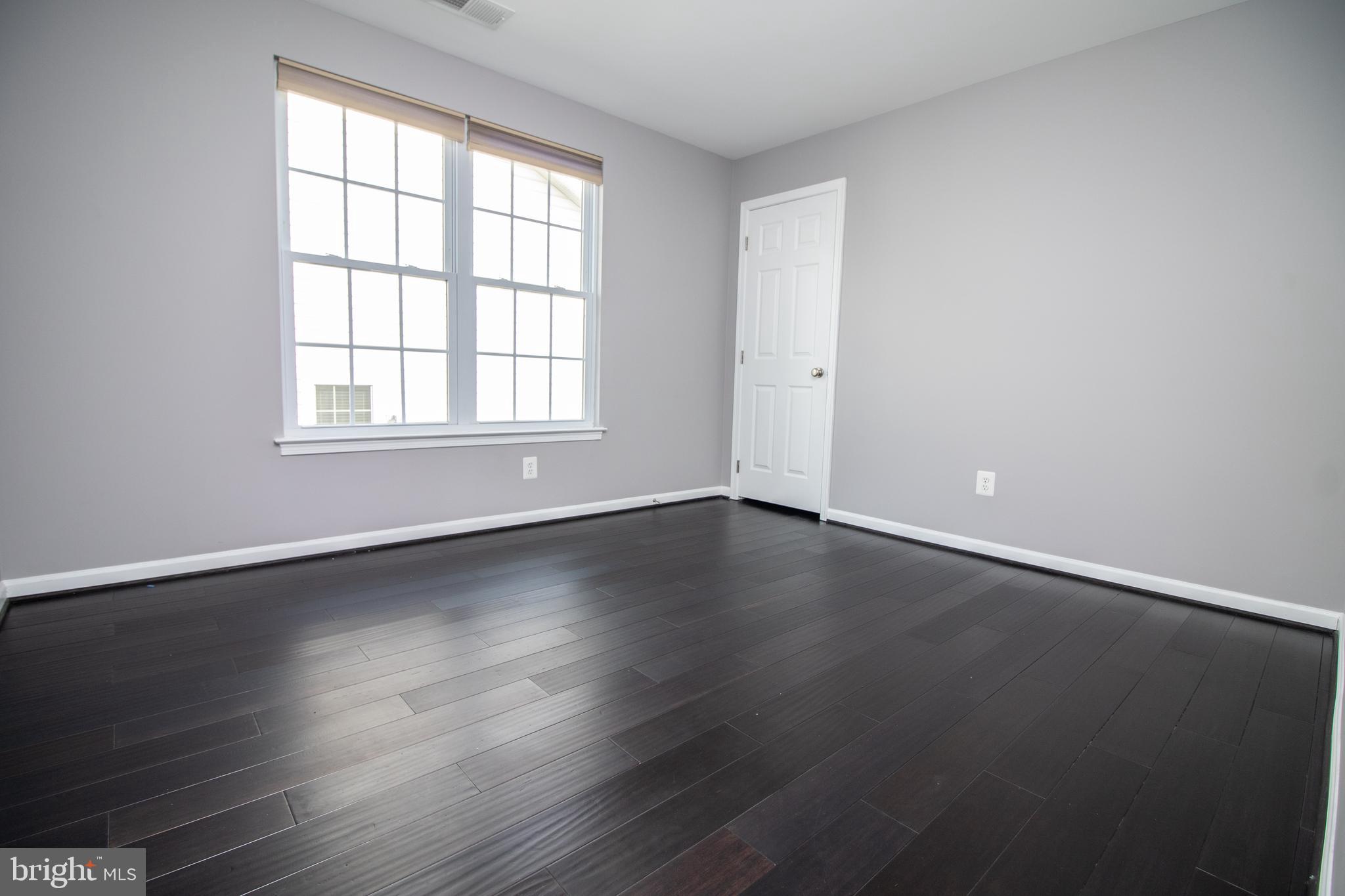 25257 Doolittle Lane Chantilly, VA 20152 - Photo 26 of 52 an empty room with wooden floor and windows