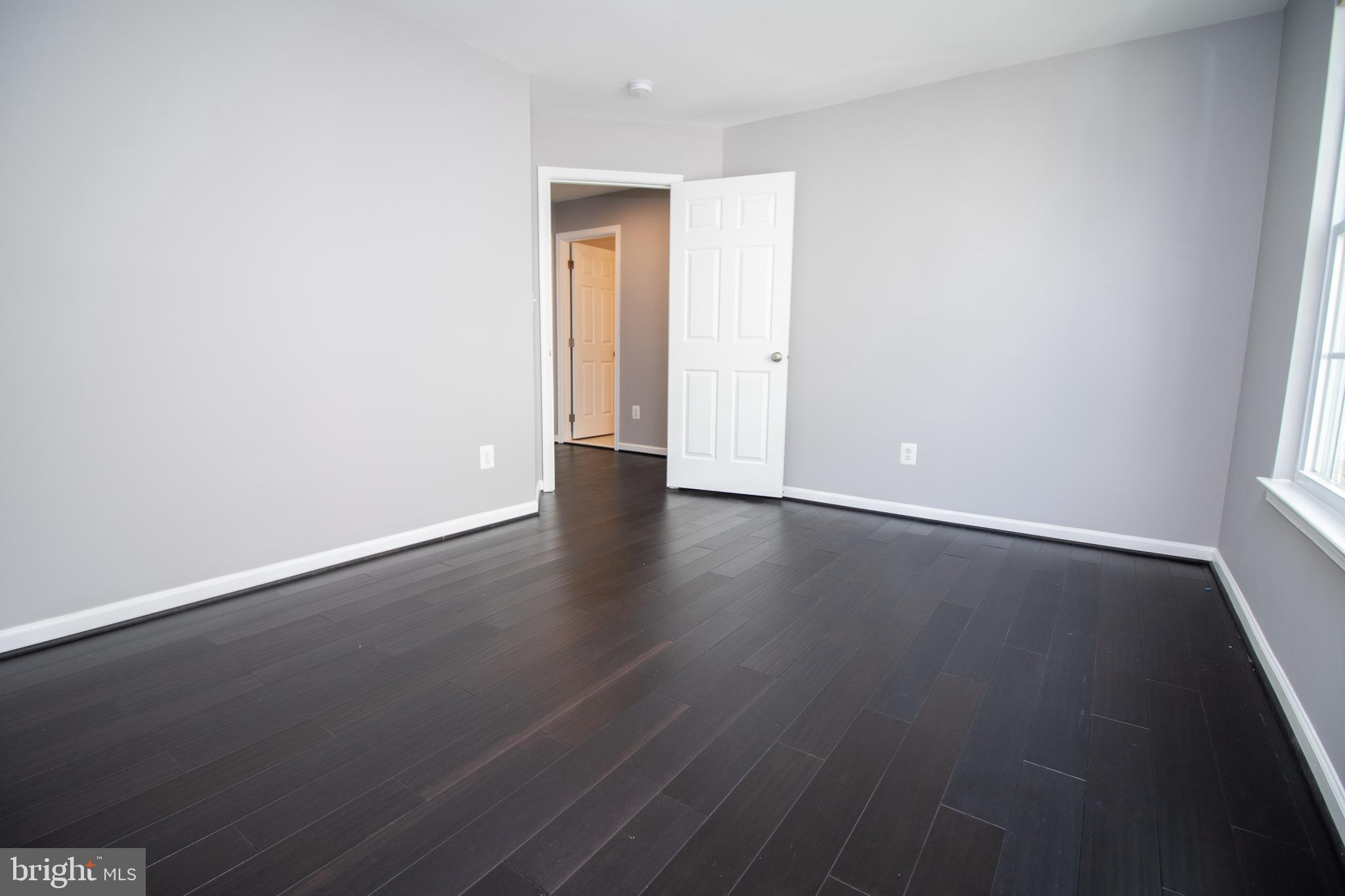 25257 Doolittle Lane Chantilly, VA 20152 - Photo 27 of 52 an empty room with wooden floor and windows