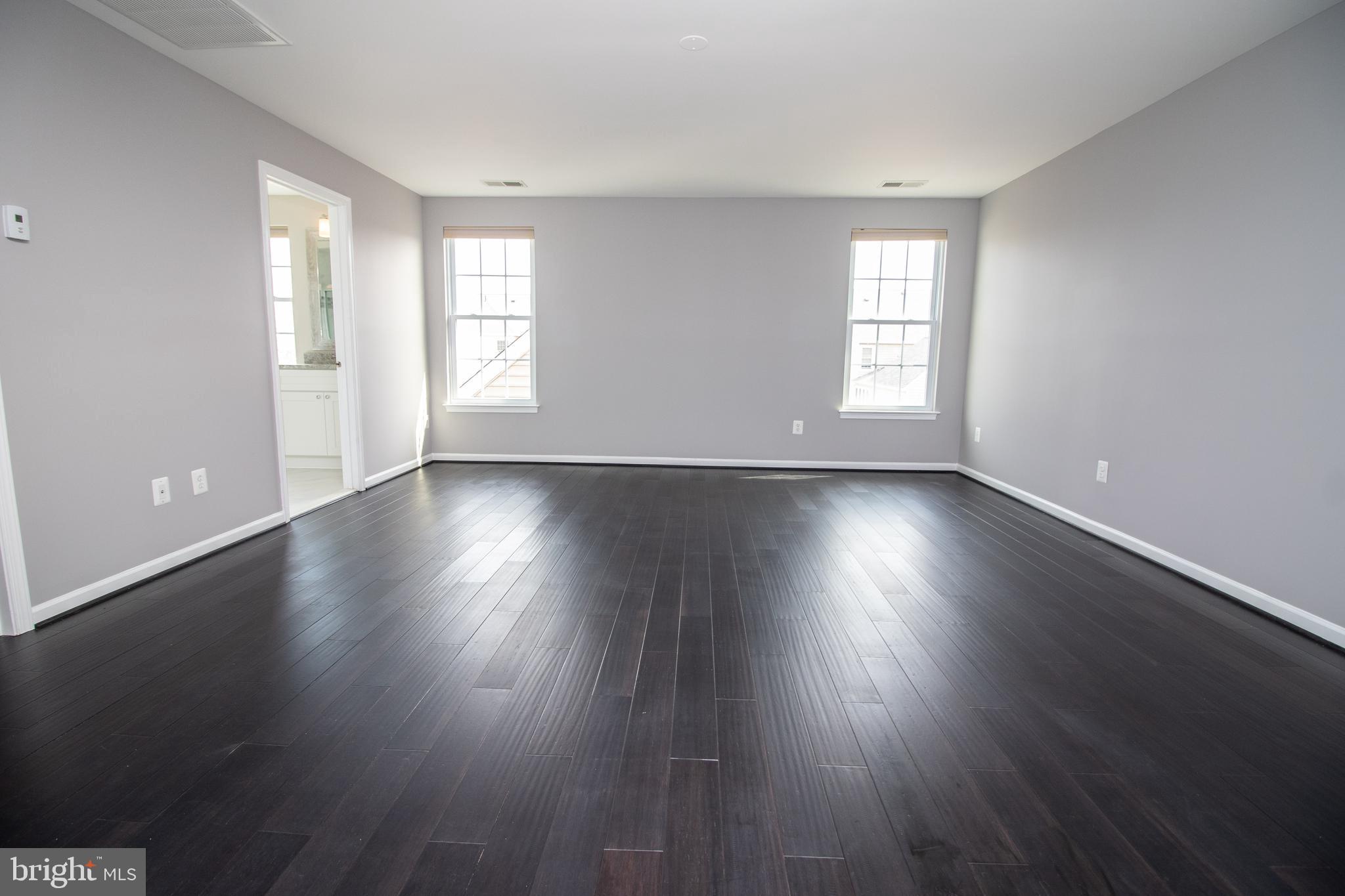 25257 Doolittle Lane Chantilly, VA 20152 - Photo 30 of 52 a view of an empty room with wooden floor and a window